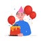 Person with cake. Old man in a festive cap blows out the candles on the cake.