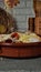 Person is carefully pouring cheese into a bowl filled with a variety of ingredients