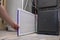 A person changing an clean air filter on a high efficiency furnace