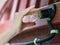 Person changing light bulb on wooden roof of village house. Close up of hand and light bulb