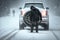 person, changing tires on car in the middle of winter storm