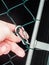 Person checking a carabiner lock at a gate