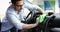 Person cleaning car with microfiber clot and maintaining shine