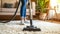 Person Cleaning Plush Carpet with Modern Vacuum Cleaner.