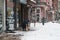 A person cleaning snow of a street in Sofia, Bulgaria. Cold winter weather in Europe. Snowy white street.