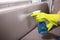 Person Cleaning Sofa With Spray Bottle
