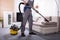 Person Cleaning Sofa With Vacuum Cleaner