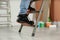 Person climbing ladder indoors, closeup on feet