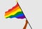 Person of color waving a rainbow flag, from the lgbt+ community