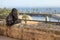 Person contemplating a park facing the sea