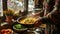 Person cooking a colorful dish garnished with herbs in a cozy kitchen.