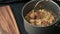 A person is cooking instant noodles in a meatball soup while the beef broth is boiling and steam is gushing out. Photo, top view,
