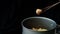 A person is cooking instant noodles in a meatball soup while the beef broth is boiling and steam is gushing out. Photo, top view,