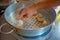 Person cooking a momo food over a metallic tray in the kitchen, type of South Asian dumpling native to Tibet, Nepal