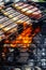 Person cooking steaks on a barbecue grill