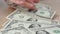 Person counting dollar banknotes in hands. Stitch of money. Rich man.