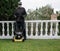 Person with covid mask poses next to his mower before preparing the garden