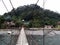 A person crosses a bridge over the Bahorok River in Bukit Lawang in Indonesia