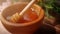 A person is dipping wooden spoon in honey. Golden fresh honey is pouring from stick. Organic beekeeping. Concept of
