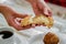 Person dividing a piece of bread into two parts