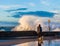 Person with dog watching crusing waves