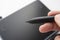 A person draws on a graphics tablet. The hand holds the touch pen. Wired graphic tablet for designer and artist.