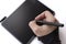 A person draws on a graphics tablet. The hand holds the touch pen. Wired graphic tablet for designer and artist.