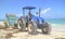 Person driving a tractor and cleaning the beach