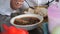 Person eating beef bone soup and a plate of rice for dinner on the table.