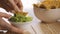 Person eating guacamole while scooping a chip