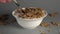 A person eats oatmeal with dietary milk, eating them with a spoon