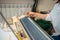 the person is engaged in knitting on a household knitting machine. handmade