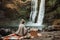 person, enjoying picnic in front of scenic waterfall with basket and blanket