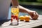 person, enjoying refreshing glass of fruit-infused water on hot summer day