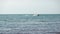 Person enjoying water jet ski in a blue sea on a sunny day. Tropical holiday water activities