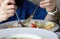 Person enjoys eating with fried rice and blur soup foreground