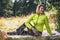 Person exercising outdoors in green park, activity with stretch legs. Smile fitness woman stretching exercises training outside