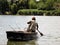 Person Fishing in the River from a boat