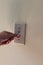 Person flipping light switch on a wall