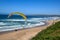 Person flying his paraglider on the beach of Wilderness, South Africa