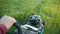 Person gardener, mowing green grass lawn mower, Sunny day, close-up