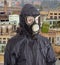 Person in gas mask against the backdrop of abandoned production