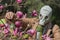 A person in gas mask exploring infested various plants and flowers