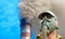 Person in gas mask on industrial smoking pipe background.