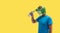 Person gesture with frog mask drinking fresh drinking water from a plastic bottle harming the ecology on yellow background