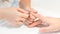 A person gets nails done. Hands closeup, vertical view