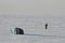 Person getting ready to kite skiing under grey overcast skies near Cambridge Bay