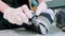 Person in gloves cleans sole of stylish sneaker at table