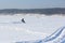 The person going on a snowmobile on the frozen river