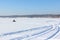 The person going on a snowmobile on the frozen river